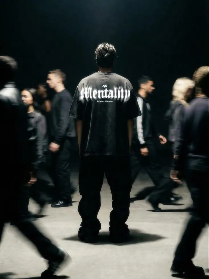 Crowd of people in black streetwear facing away from the camera